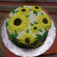 Sunflowers butter cream piped sunflowers on the cake in no specific pattern