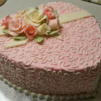 Valentines Day Heart Buttercream with flowers and ribbon made from a candy clay/fondant mix.