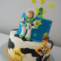 Toy Story 6 and 9 inch tiers iced in buttercream with fondant figures and accents.