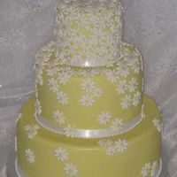 Yellow Daisy Yellow cake covered with small white fondant daisies.