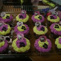 Hello Kitty Guitar Pick Cupcakes Triple chocolate cupcakes with white chocolate icing. The toopers are guitar picks and sugar music notes. They went with the guitar cake I...