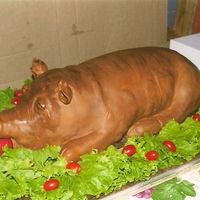 Luau Pig Roast This was a roasted pig cake presented to a friend at his retirement party which was a luau. He was actually the one being roasted.
