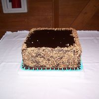 No Nonsense Grooms Cake Chocoholic's Delight, Fudge Chocolate cake, Fudge filling and poured special dark chocolate fudge topping with crushed pecans around...