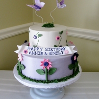 Flowers & Butterflies Girly cake for cousins that share close birthdays. Cake iced in bc, decorations & butterflies are fondant.