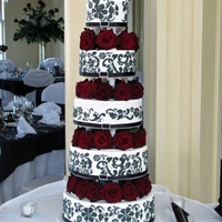 Black, White & Red Elegance All tiers fondant covered and then stenciled with RI in a design similar to that on the bridesmaid dresses. Nerve wracking set up but worth...