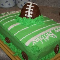 Football Cake Layered yellow and chocolate cake with choc. mousse filling, bc icing and the football is made out of rice krispies and covered with...
