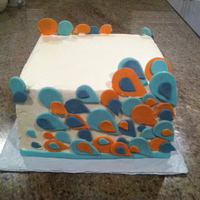 Anniversary Artsy Cake This was a request for a square cake with some artsy teardrop shapes. The colors were orange, teal, and grey.