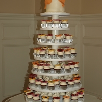 Cupcake Wedding Tower Red Velvet cupcakes with cream cheese icing. Cake is also Red Velvet with gumpaste bow