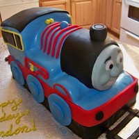 A Train Cake That Looks Similar To The Licensed Character Thomas The Train! Thomas is licensed so meet Tim the Train!! Carved cake, MMF details and gumpaste face. Thanks for looking!