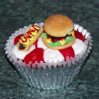 Picnic Cupcake With Burger And Hot Dog This was fun to do! Hot Dog is made by cutting end off of a Fig Newton, the patty is a Junior Mint, and the bun on the hamburger is made...