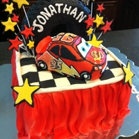 Lightning Mcqueen Tire Cake This is a 8" square cake draped with MMF. McQueen and the tire are both rice crispie treats covered in fondant and decorated with...