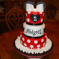 Abigail's Minnie Mouse Cake 10,8 & 6 inch round tiers covered in fondant. Gumpaste bow and fondant decorations.