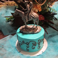 Country Scroll 6" round, aqua buttercream frosting with brown scroll work.