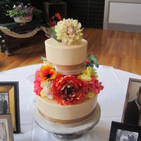 Vintage 2 tier, champagne colored buttercream with ribbons and silk flowers.