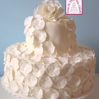 Romantic Rose Petal Wedding Cake A simple two-tiered cake for a small, initimate event. Cake was covered in fondant. 250 hand-made rose petals were created from gum paste,...