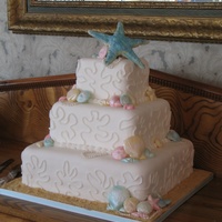 Covered With Fondant Piped Coral Seashells Are Made From White Chocolate And Brushed With Pearl Dust Pearls Are Handmade Giant Star Top Covered with fondant, piped coral, seashells are made from white chocolate and brushed with pearl dust, pearls are handmade, giant star...