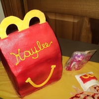 Happy Meal 3 layer cherry cake, airbrushed buttercream. Decorations are fondant, red gel for the catsup and 1 purchased happy meal toy. This is only...
