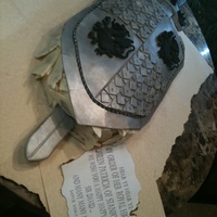 Sword And Shield Cake is a white chocolate cake with white chocolate butter cream. It is surround by white chocolate chunks. Sword and shield are all made...