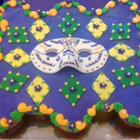 Mardi Gras Cupcake cake decorated with buttercream, fondant accents, and gumpaste mask.