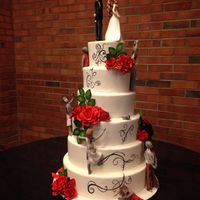 Zombie Wedding Cake Six tiers of mixed flavors covered in white chocolate ganacheunder MMF. Gumpaste roses and zombies, bride and groom. For my sister's...