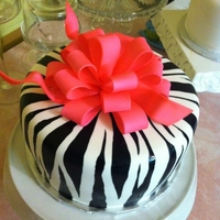 Zebra & Pink Bow A 40th Bday cake, this was created with white cake and MMF, hand painted zebra pattern with a gum paste bow, airbrushed hot pink.