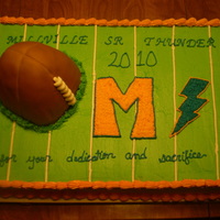 Thunderbolts Football Banquet Sheet cake with a hand carved football exploding out of the turf for a home town teams football banquet. Go Thunderbolts!