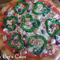 Combo Pizza 14 in round cake made to look like a combo pizza. All toppings were made from gumpaste/white chocolate mix.