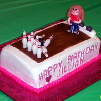 Bowling Cake Bowling themed cake for 6 year old. My first figurine to make and she was a bit top heavy...I think her head was too big! They loved it...