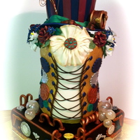 Whimsical Steam Punk Wedding Cake Whimsical, vintage, steam punk themed wedding cake brings not only the elements of steam punk, but adds a splash of peacock colors to its...