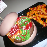 Burger And Fries marble cake covered in fondant with fondant garnishes, RI condiments, RK pattie and fries. very fun to make!!