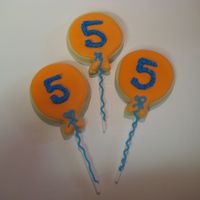 5Th Birthday Balloon Cookies The birthday boy wanted orange balloons w/ blue strings. So, that is why they are on sticks :)