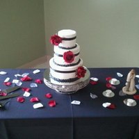 Simple Black & Red 8" & 6" vanilla cake, 4" chocolate cake all with fresh raspberry filling & buttercream frosting. Fabric ribbon &...