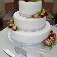 Wedding Cake With Fresh Flowers Chocolate cake moistened with hazelnut syrup, frosted with italian butter cream and covered with fondant. Decorated with fresh flowers and...