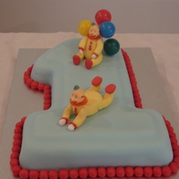 Clown - 1St Birthday Marble cake. Clowns are made from fondant except the heads, they are plastic.