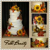 Fall Beauty *3 tier fondant wrapped with gumpaste flowers and leaves, fondant pumpkins and caramel/tootsie roll acorns.