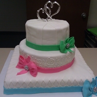 Pretty Little Bow Wedding cake for a friend's candy-color themed wedding. Chocolate cake on the top and bottom tiers, White cake on the middle tier. All...
