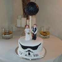 This Was A Cake For The Star Wars Loving Groom With A Storm Trooper Cake And Princess Leah And Hans Solo And The Death Star Spraying Sparkl... This was a cake for the Star Wars loving Groom. with a storm trooper cake and Princess Leah and Hans Solo and the Death Star spraying...