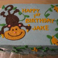 Monkey Cake 1/2 sheet cake frosted in buttercream. Monkey, vines and bananas in buttercream.