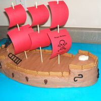 Pirate Ship Yellow cake frosted with chocolate buttercream. Royal Icing accents. Really wanted to make the sails out of white Chocolate but it was just...