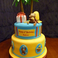 Curious George B-day cake for friend's 2 yr old who loves Curious George. Yellow cake. Palm tree leaves and George are Gum paste, Hat & present...
