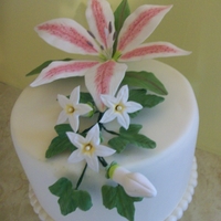 Stargazer Lily Cake was covered in fondant with a fondant bead border that was dusted with pearl dust. Stargazer lily, stephanotis & bud and ivy...