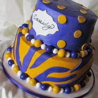 Lsu Girly Cake Top tier is Strawberry Cake with Cream Cheese filling, bottom tier is Dark Chocolate Fudge cake with Chocolate Ganache filling. A white...