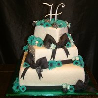 Wedding Cake- Colors Teal, Black, And White This was a three tier wedding cake. The brides colors were Teal, Black, and White. And the flowers she was wanting were daisies and black...