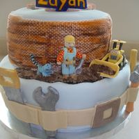 Bob The Builder Cake 2-tier bob the builder cake decorated in fondant. Took me 3 tries to make scoop the truck! Sand is brown sugar. My first time coming up...