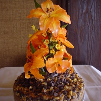 Golden Orange Hybrid Lily/orange Orchid Wedding Cake This was a wedding cake that I made for a friend of mine. It was a Chocolate Chip Walnut Cake made in a tube pan. There was a mini vase in...