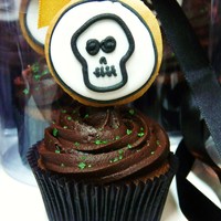 Skull Cupcakes chcolate ganache cupcake. Topping is dark chocolate ganache and a skull lollipop on top!