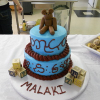 Vintage Toys Baby Shower Cake WASC cake with almond buttercream. It's topped with a fondant bear and has some wooden blocks on the table.
