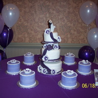 3 Tier Wedding Cake With 6 Satelite Cakes WEDDING CAKE WHITE/PURPLE-3 TIER WITH 6 SATELITE CAKES WITH FONDANT FLOWERS