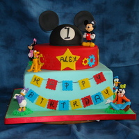 Mickey Mouse 1St Birthay French vanilla with strawberry filling. The MM hat on top is rice cereal treats. The figurines are plastic (don't mess with Disney),...