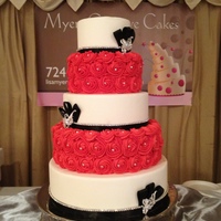 Rosette Cake 5 tier white fondant and red buttercream rosettes with rhinestone accents and trim... Show cake!